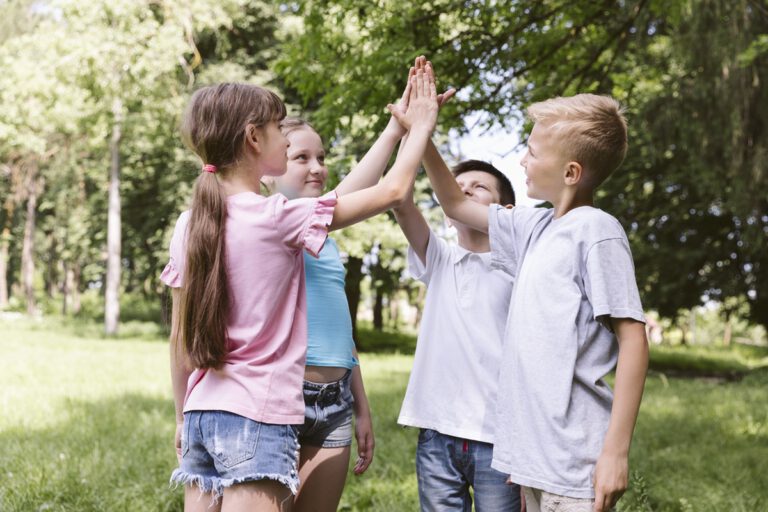 medium shot kids high fiving before match